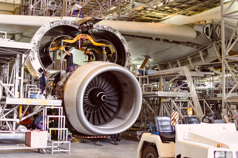 Aircraft jet engine being serviced in a hangar